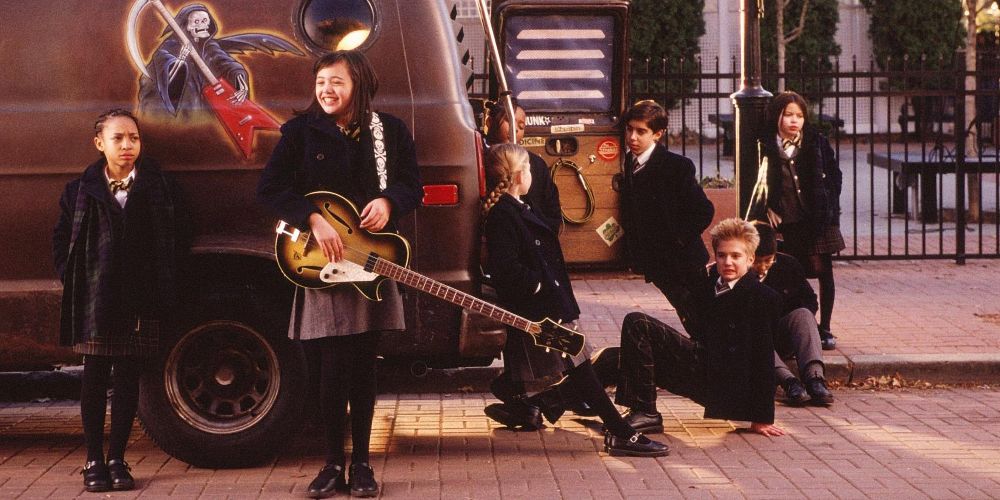 The kids pose by the van in School of Rock