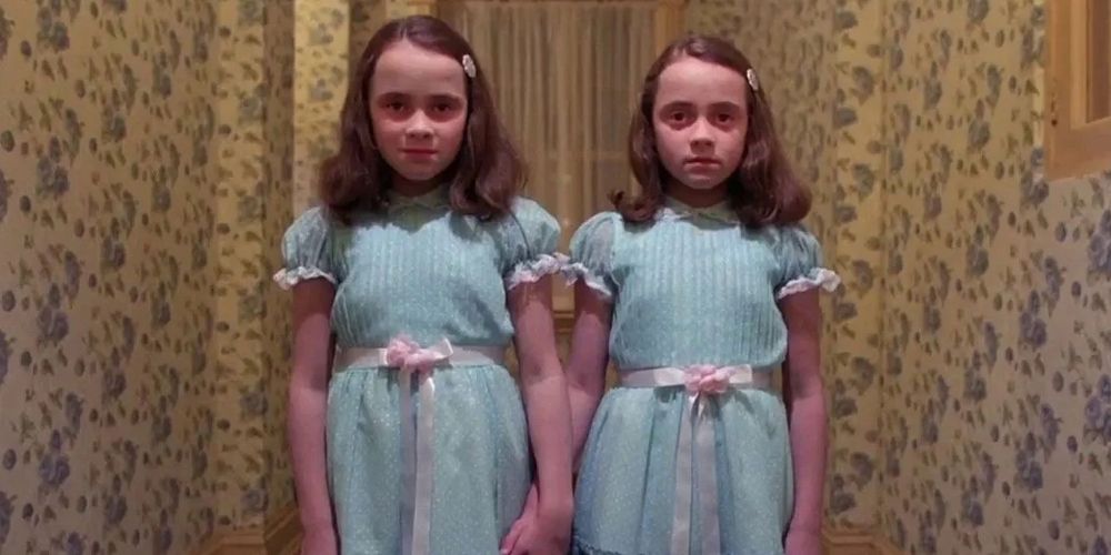 The Grady Twins stand in the hall in The Shining