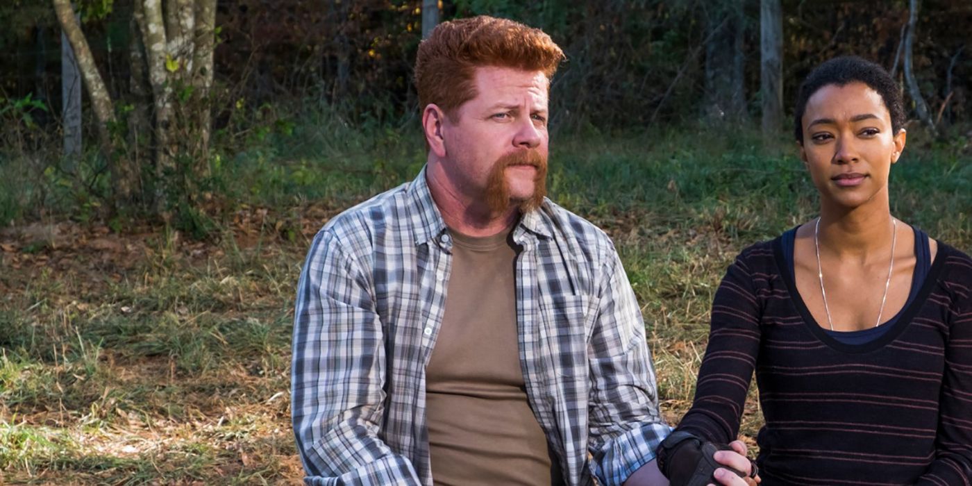 Abraham and Sasha sitting together holding hands on The Walking Dead.