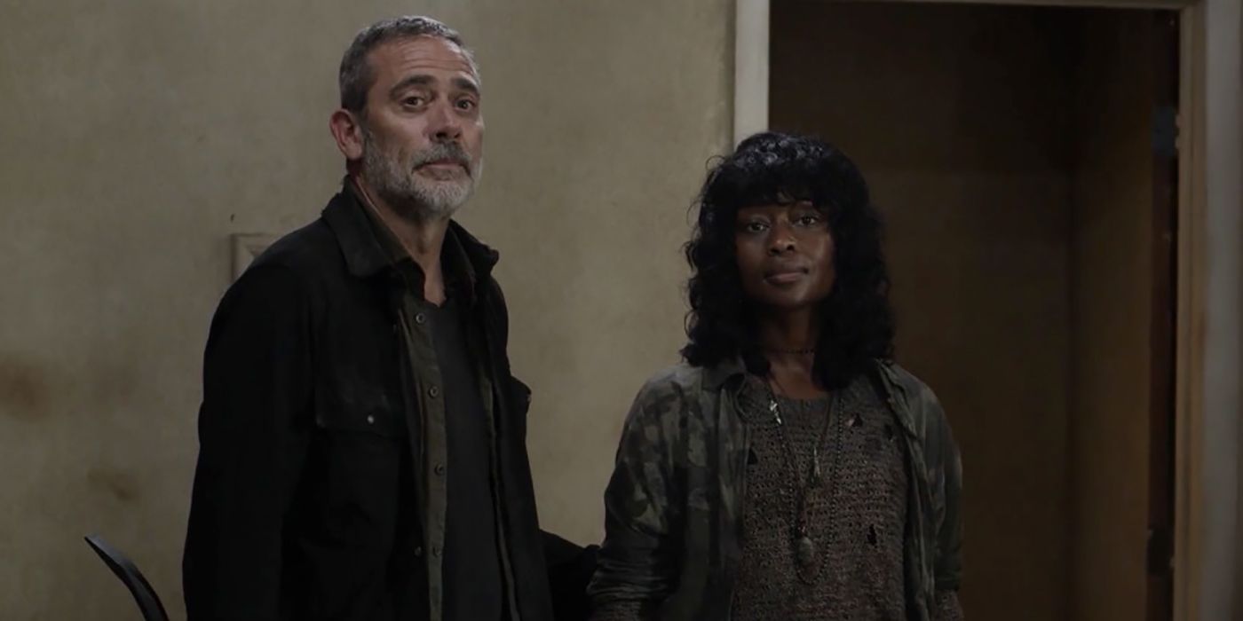 Negan with his hand on Annie's back in a scene from The Walking Dead