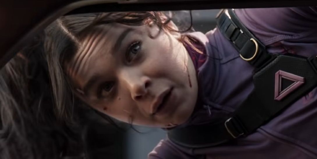 Kate Bishop hanging out of a car