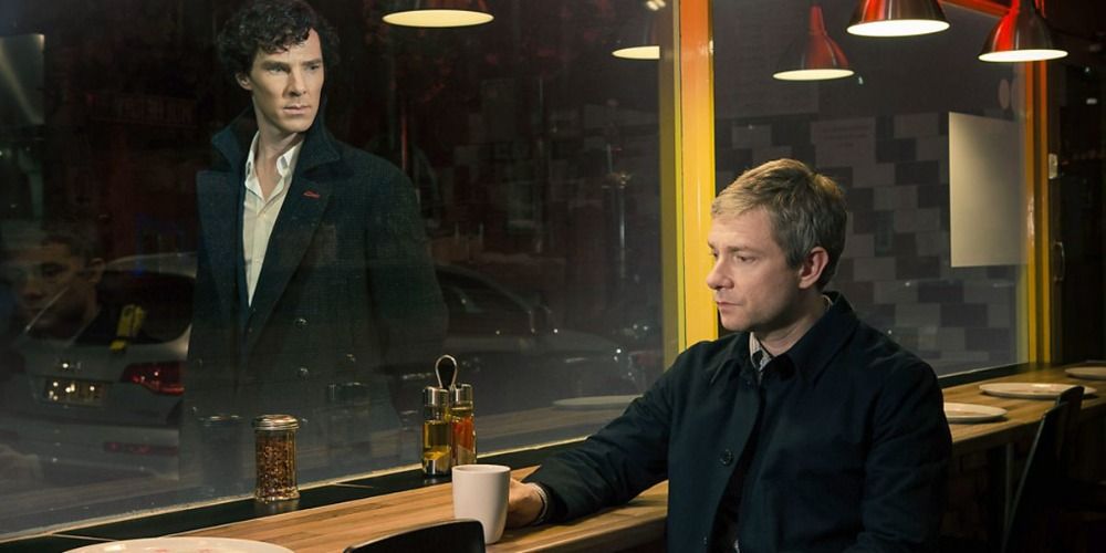 An image of Sherlock looking into a restaurant while John has a drink in the BBC Series
