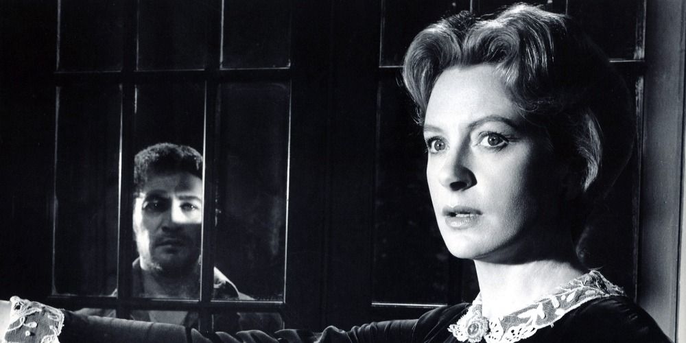 An image of a man looking at Deborah Kerr through the window in The Innocents