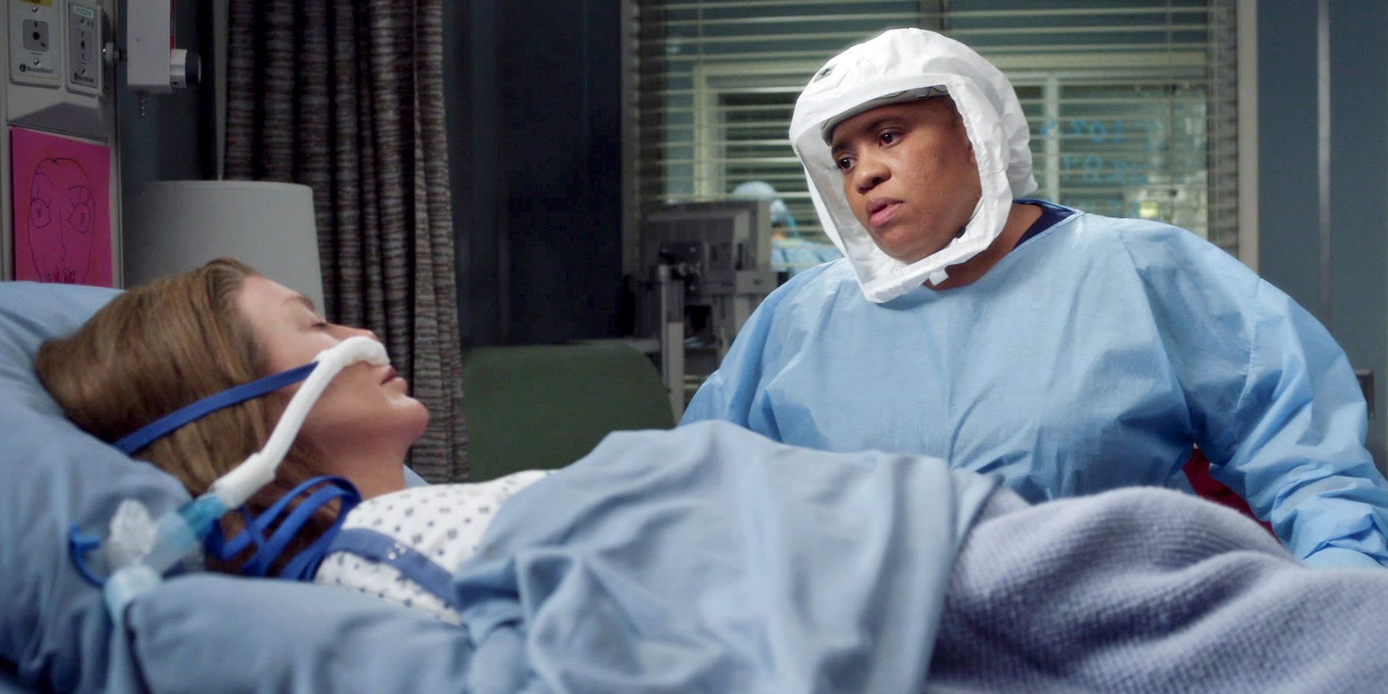 Bailey looking at Meredith in a hospital bed in Grey's Anatomy 