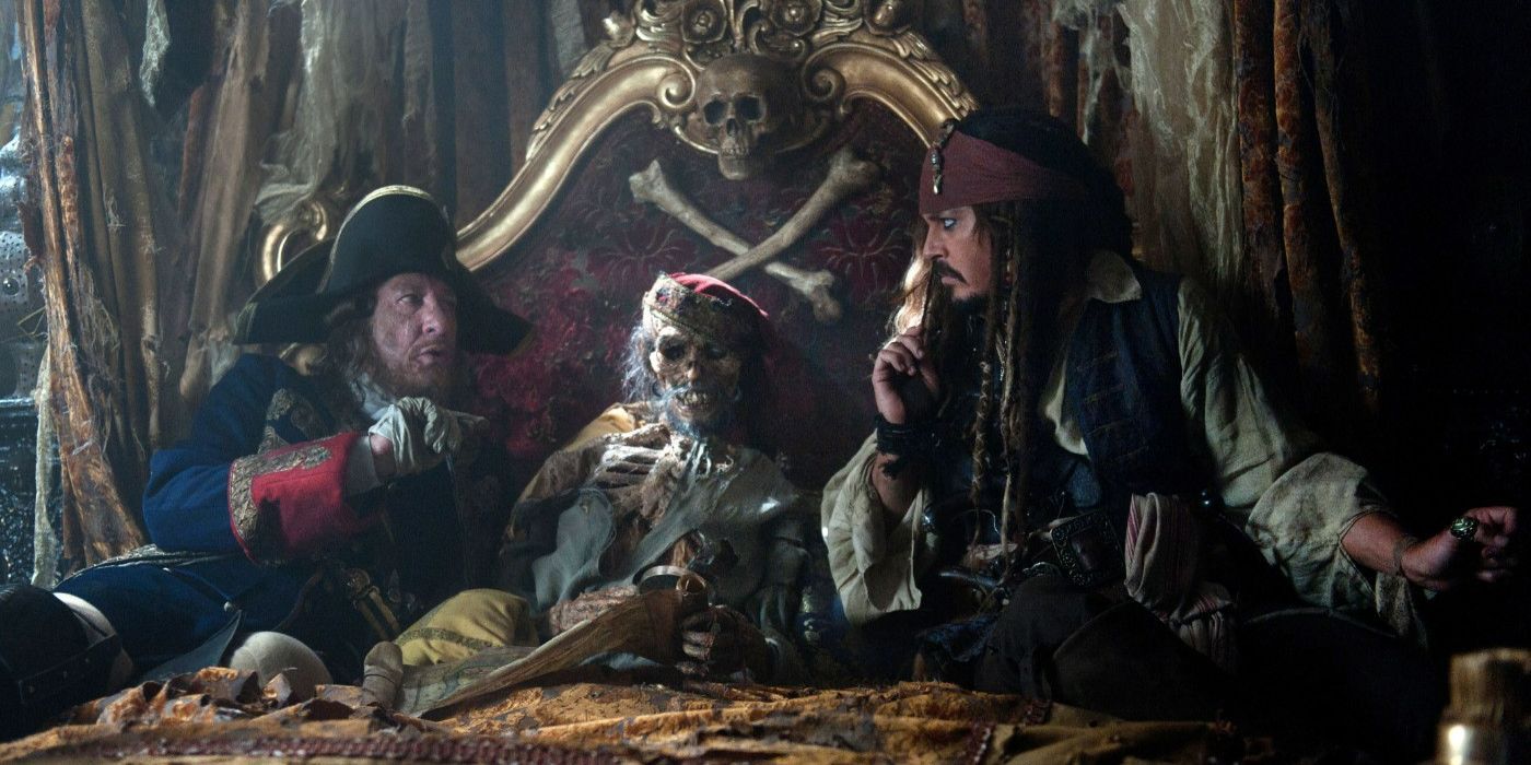 Jack and Barbossa sitting with a skeleton on a bed in Pirates of the Caribbean: On Stranger Tides