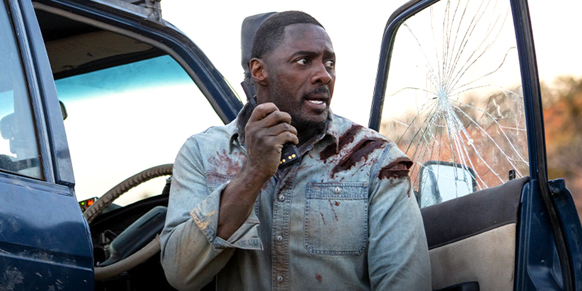 Idris Elba speaks into walkie talkie in the movie Beast