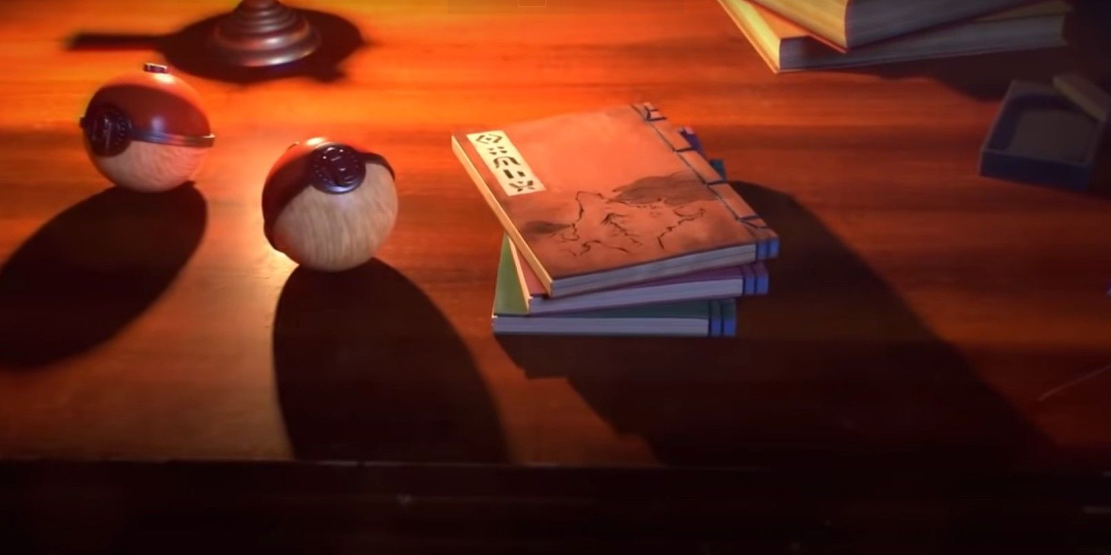 Book and pokeballs on a desk in Legends Arceus Pokemon game trailer