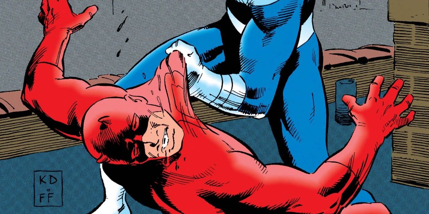 Daredevil appears defeated as Bullseye's arm clutches the shirt of his costume.