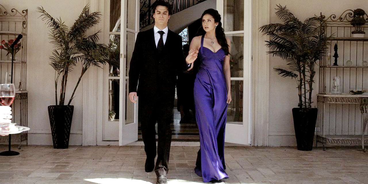 Elena and Damon together at the Miss Mystic Falls dance as they're walking out to join the dancers. Elena is in her blue dress.