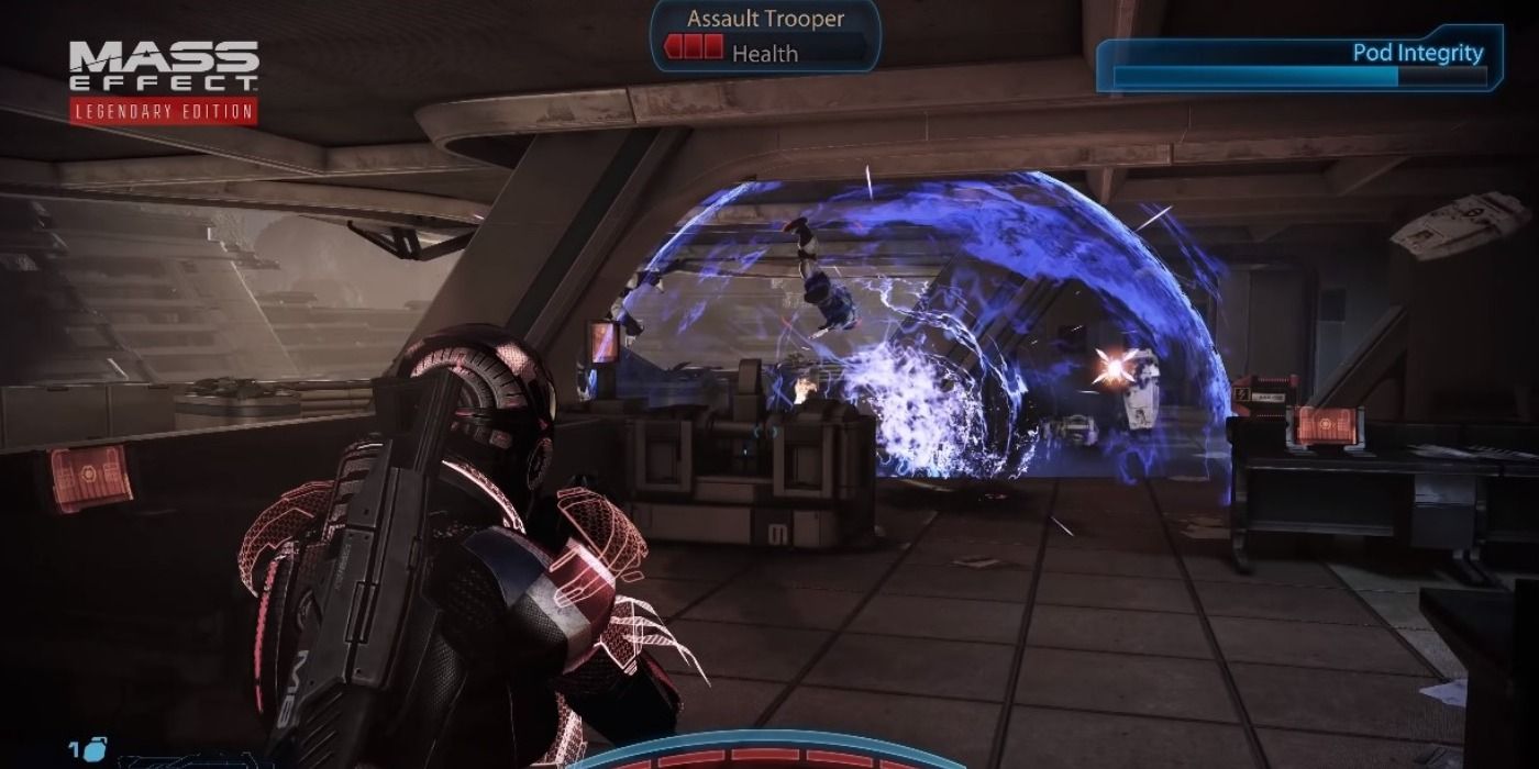 Commander Shepard throwing a grenade at an enemy.