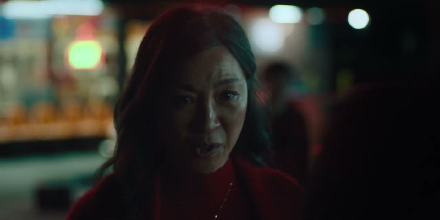 Evelyn Wang (Michelle Yeoh) looking distressed outside their laundromat in Everything Everywhere All At Once