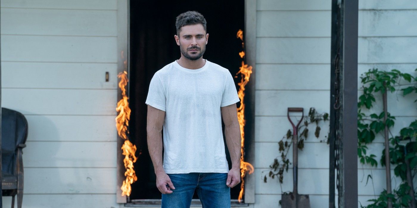 Andy standing outside a burning house in Firestarter