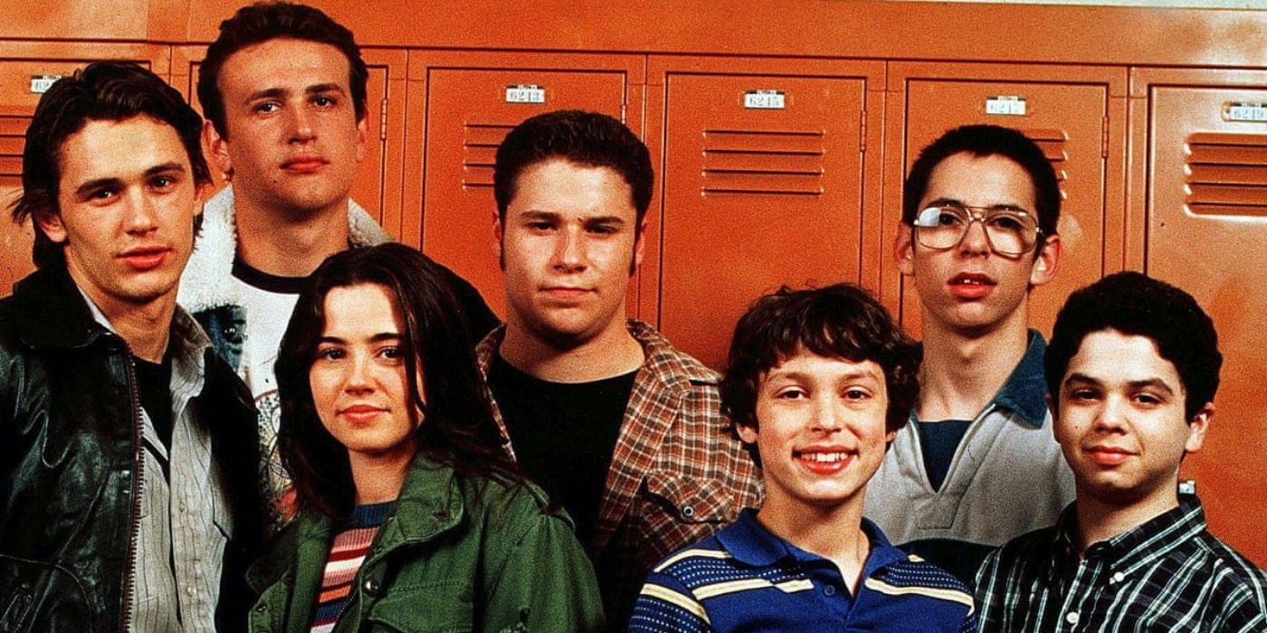 The cast standing in front of a locker
