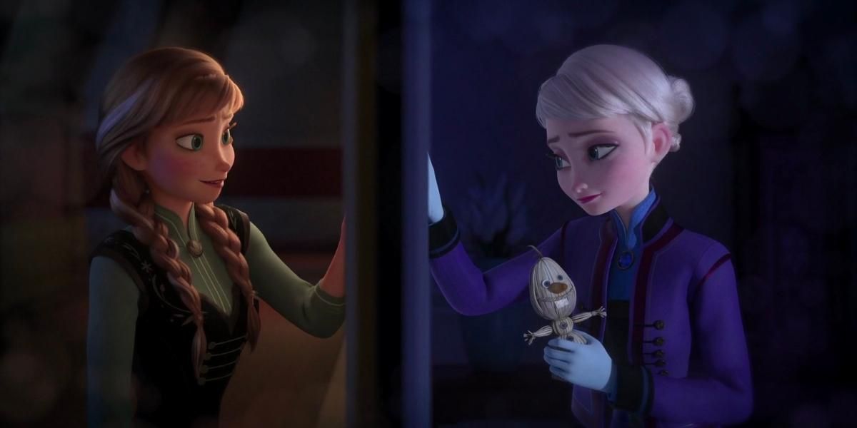Sisters Anna and Elsa reaching for each other through a door
