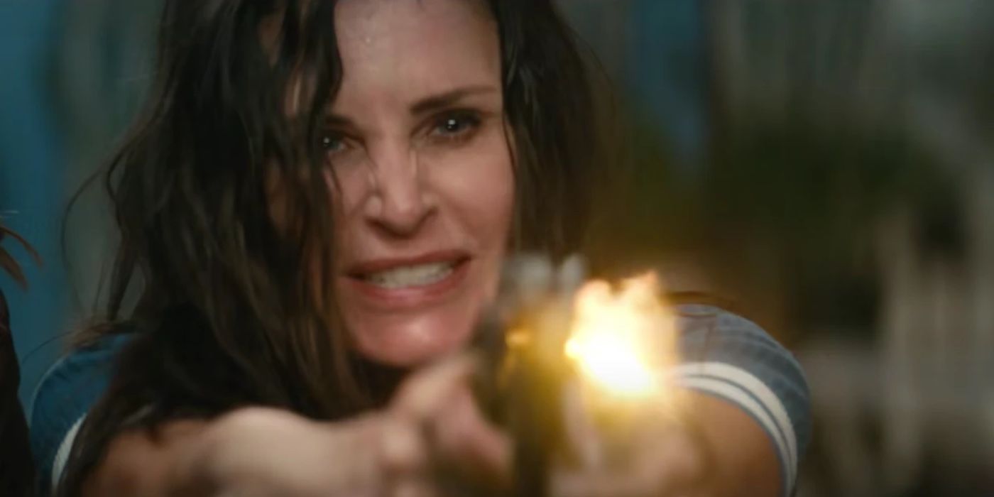 Courteney Cox as Gale Weathers firing a gun in Scream.