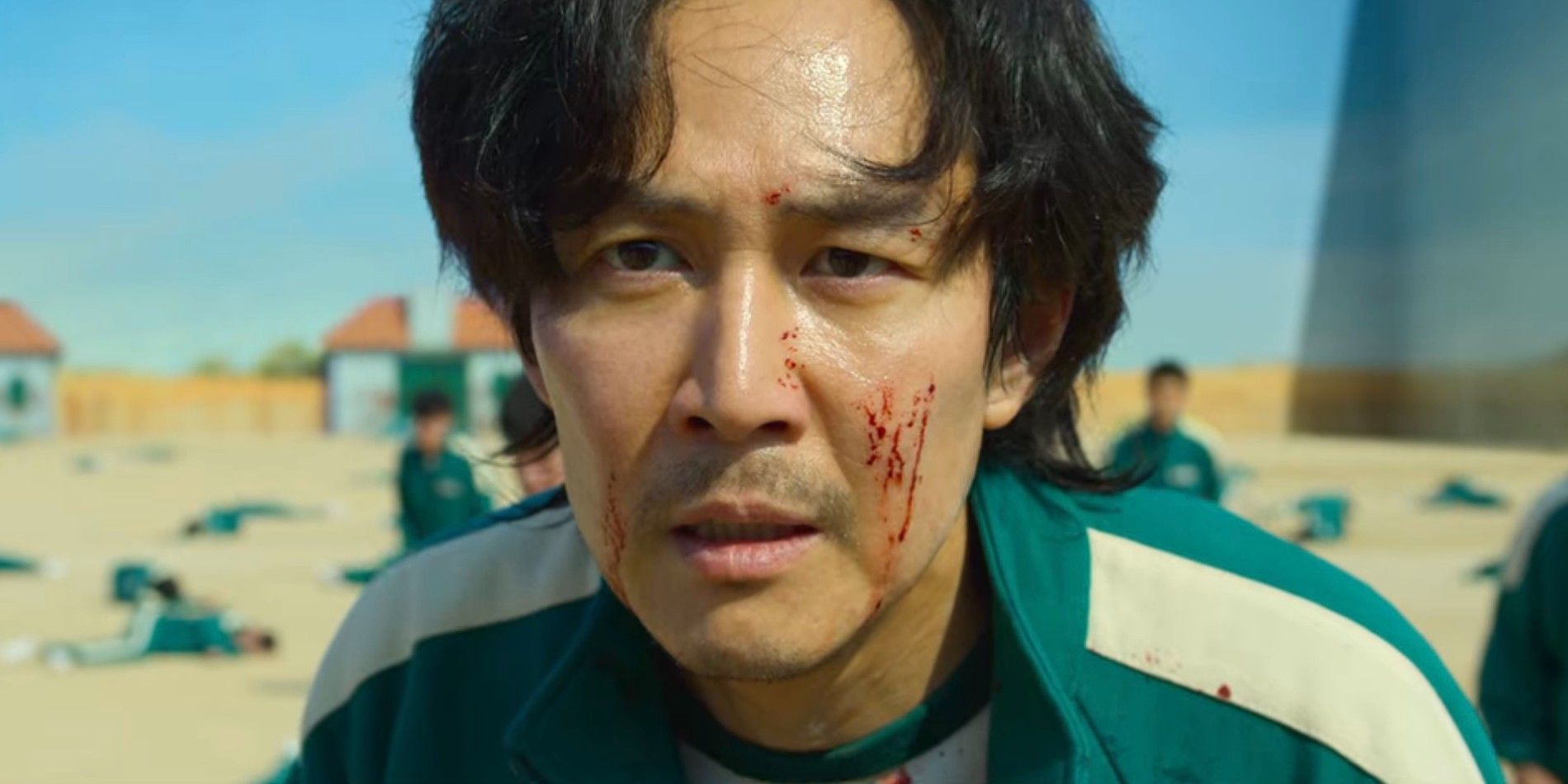 Gi-hun looking on intensely with blood on his face in Squid Game season 1