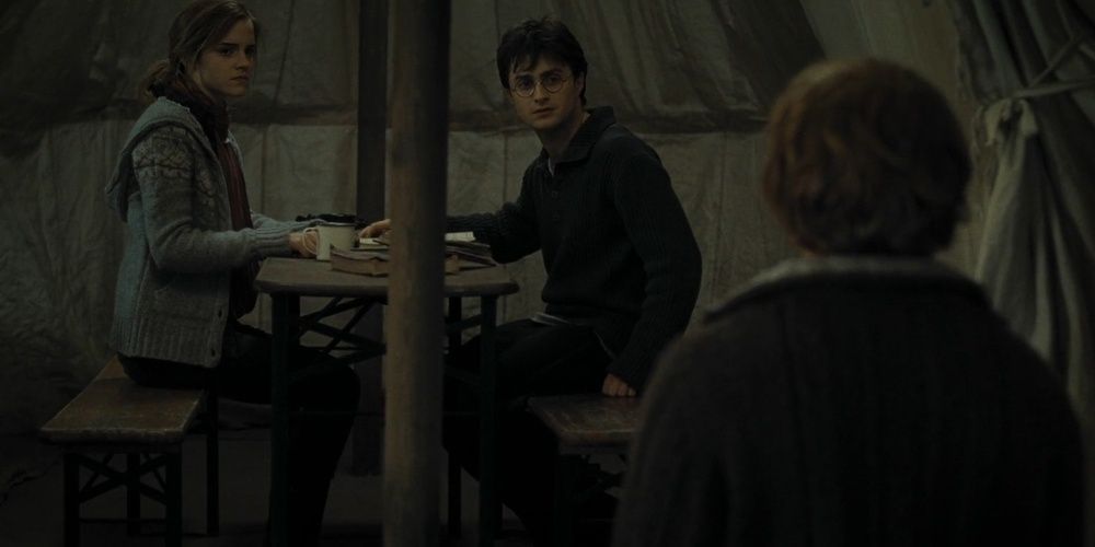 Harry Potter and Hermione looking at Ron in a tent in Deathly Hallows - Part 1 