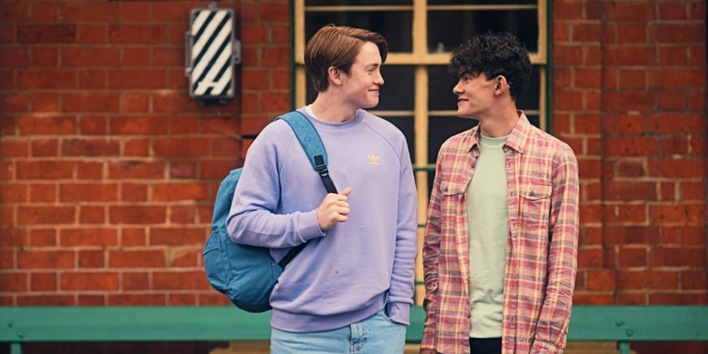 Nick and Charlie gaze at each other happily while waiting for a train in Heartstopper