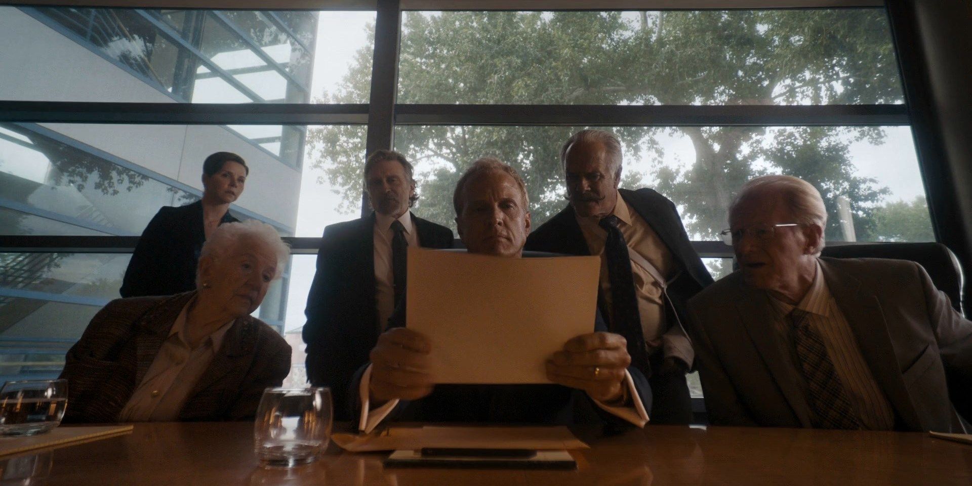 Howard holding the fake photograph in front of the room in the Better Call Saul episode Plan and Execution