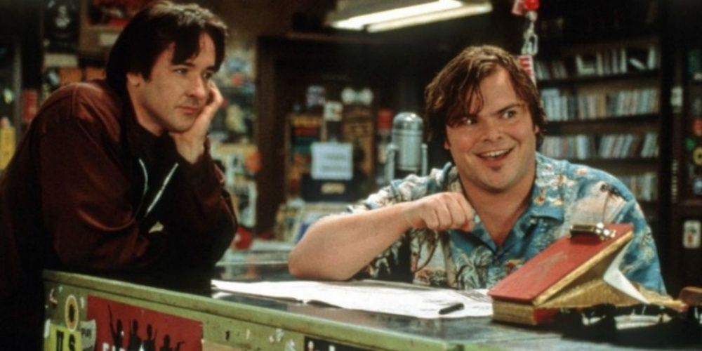 Jack Black laughs while John Cusack looks at him in High Fidelity