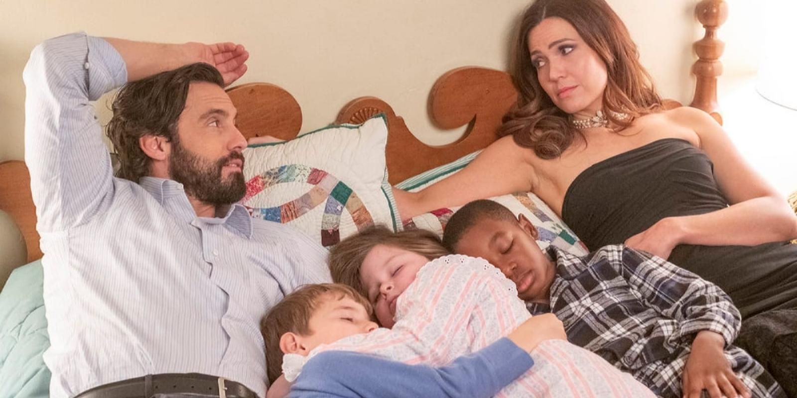 Jack and Rebecca Pearson lay down with their three little kids asleep between them in This Is Us