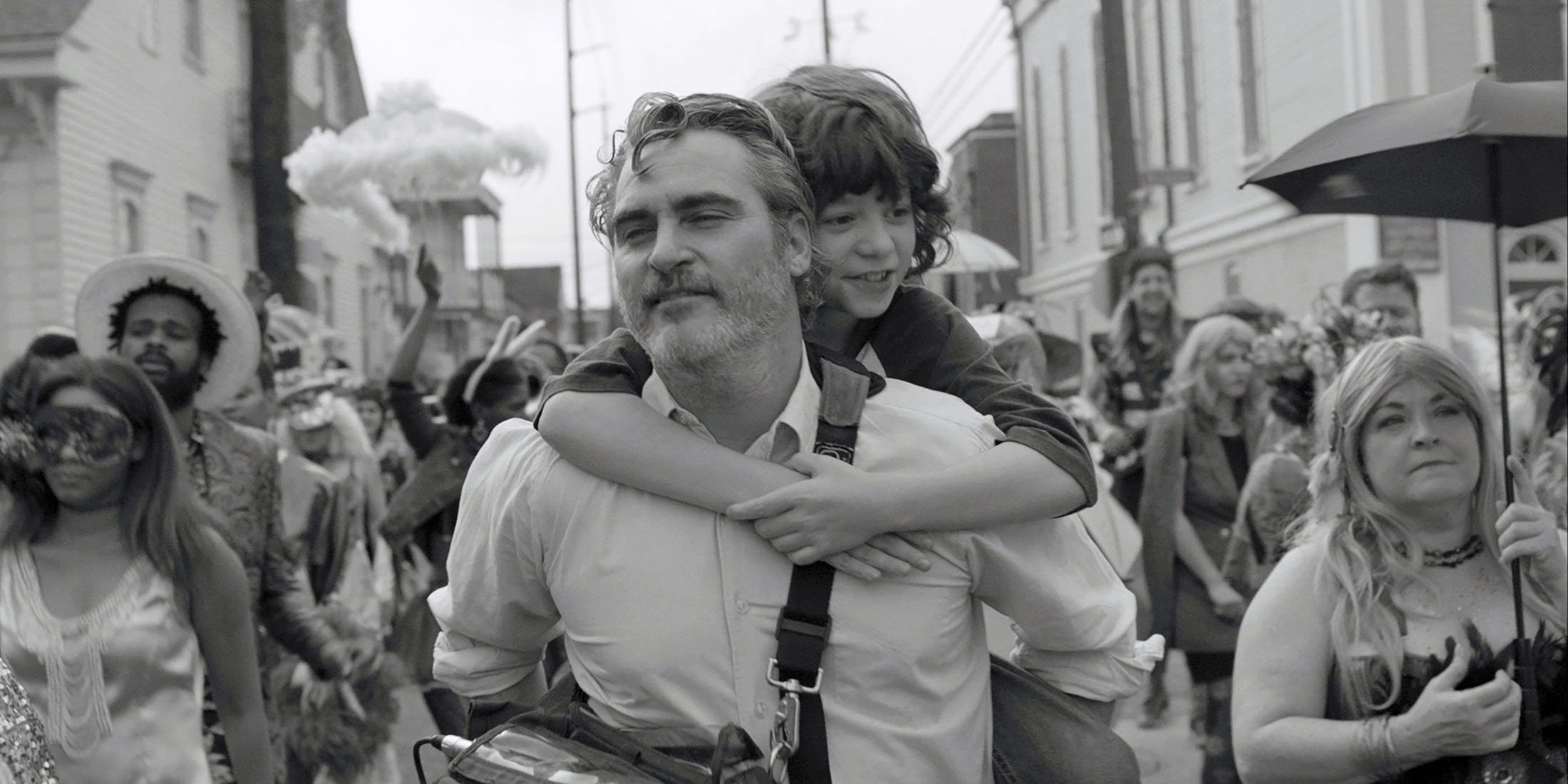 Johnny giving his nephew Jesse a piggy back ride in the movie C'mon C'mon