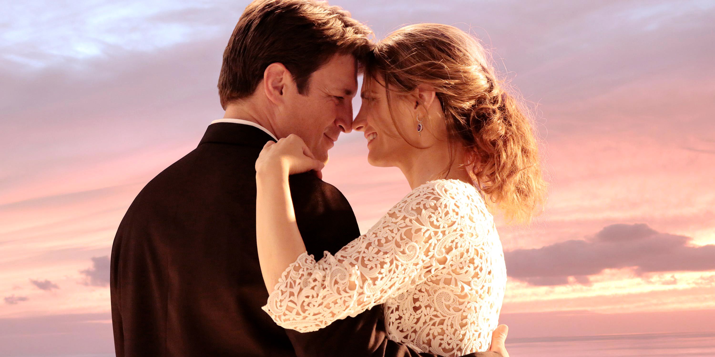 A still of Kate Beckett and Richard Castle on during their wedding with a beautiful sunset in the back.