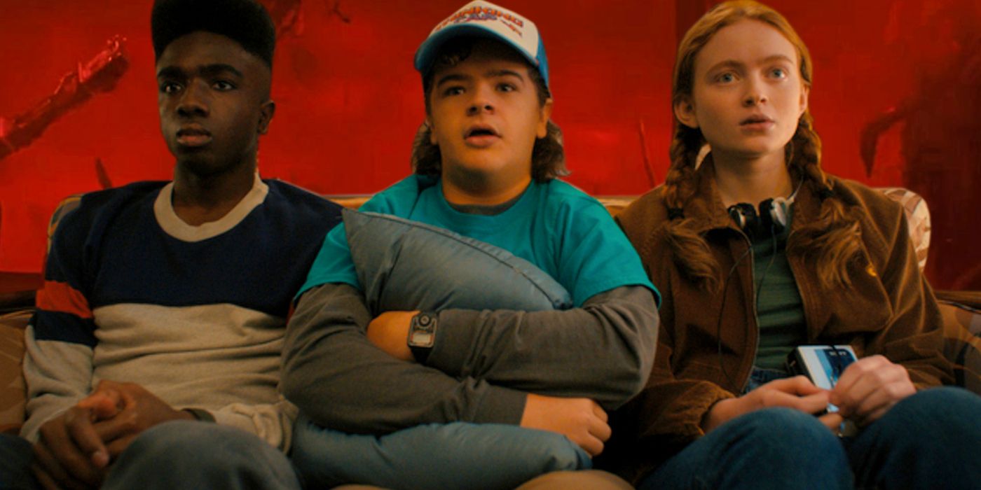 Lucas, Dustin, and Max sitting together in Stranger Things Season 4