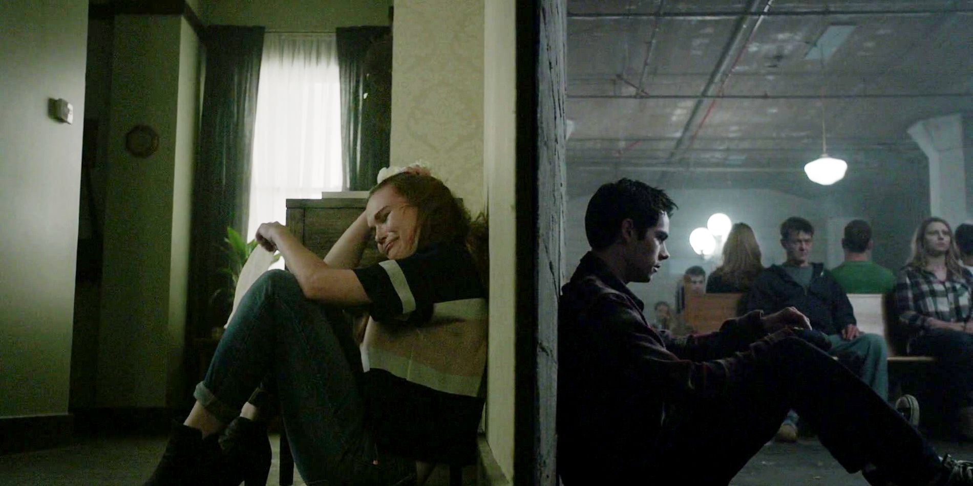 Lydia and Stiles separated by a wall on Teen Wolf, with Lydia crying and Stiles with a sad expression.