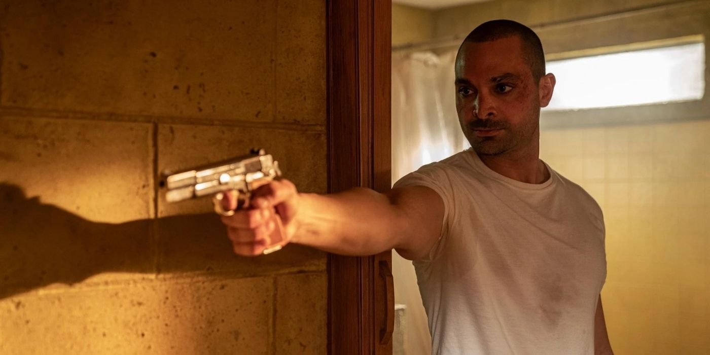 Michael Mando as Nacho Varga pointing a gun in Better Call Saul