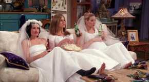 Monica Rachel and Phoebe sitting on the couch in wedding dresses and eating popcorn in Friends