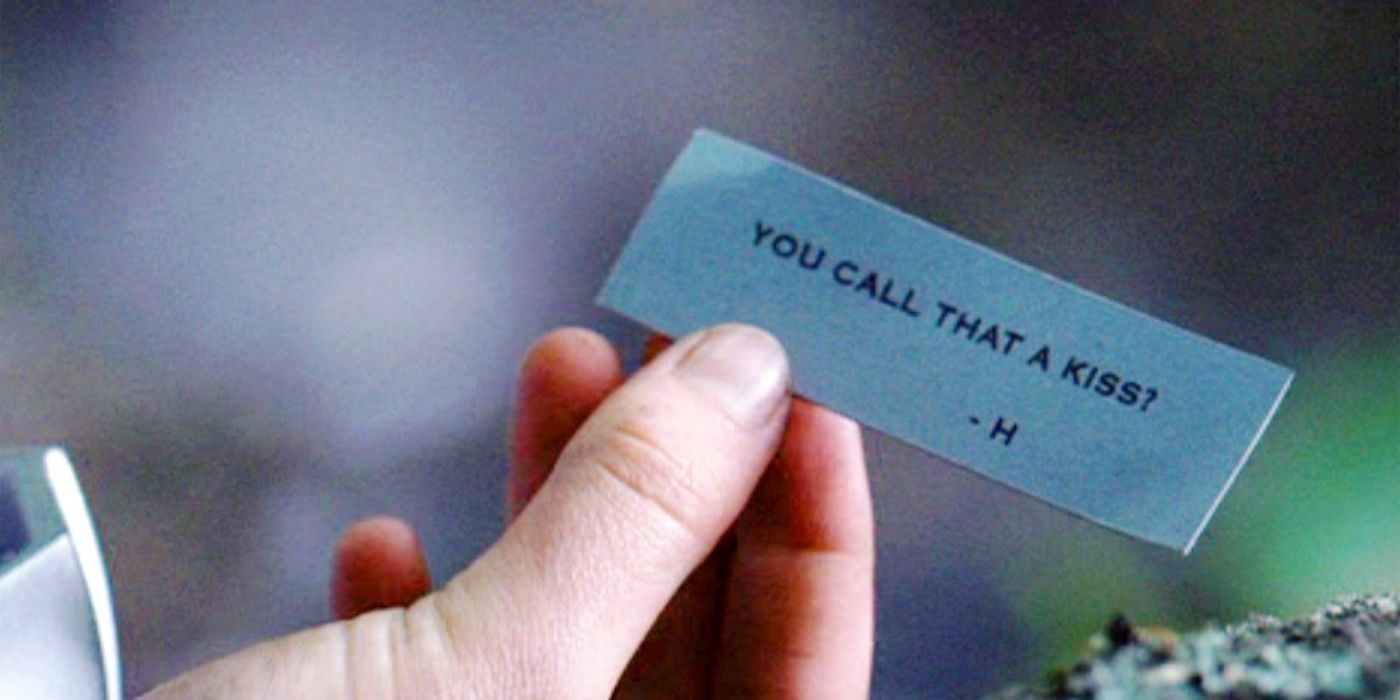Katniss holding a note from Haymitch in The Hunger Games
