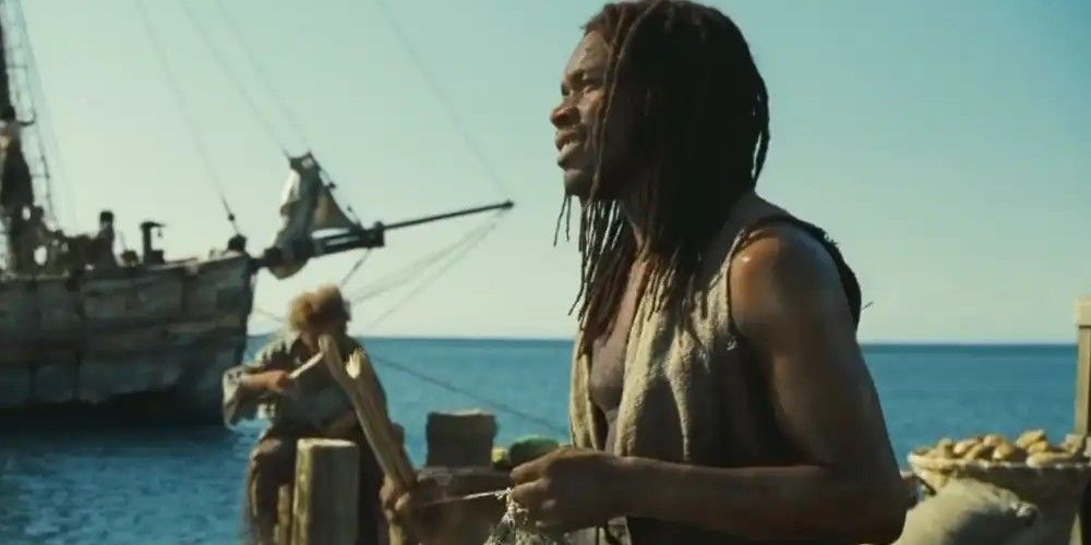 A man weaving a net on a dock in Pirates of the Caribbean