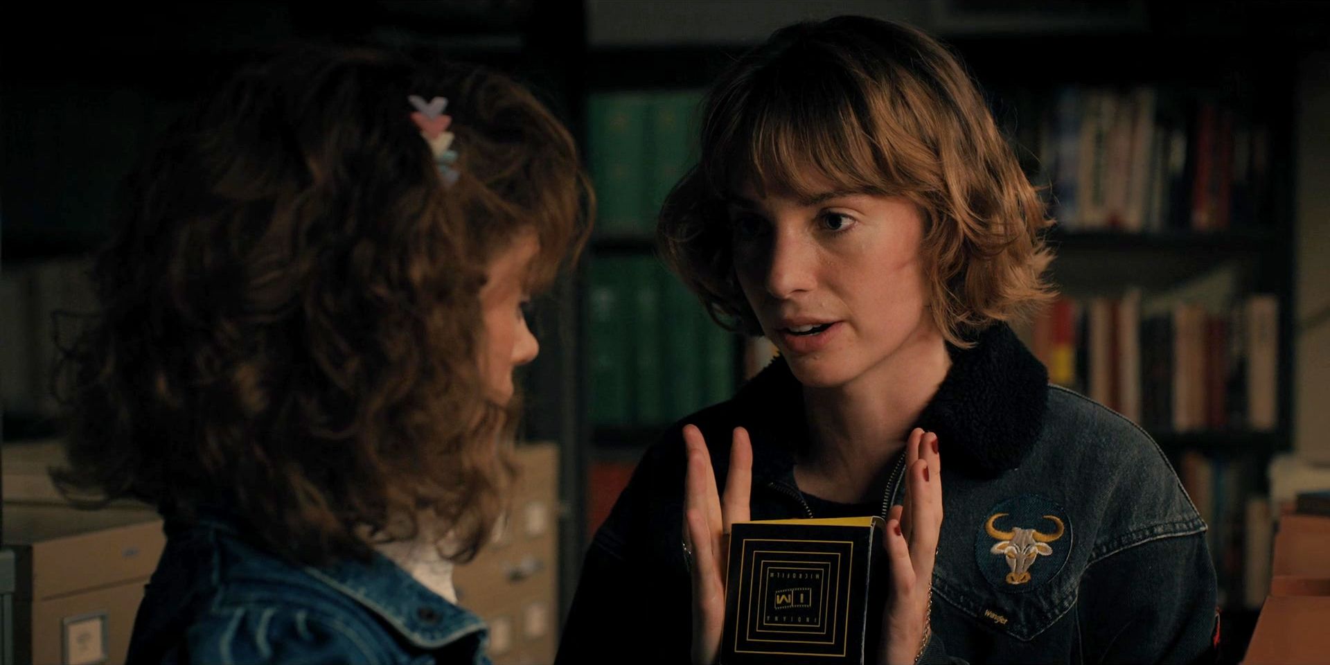 Robin Buckley holding a microfiche in Stranger Things 
