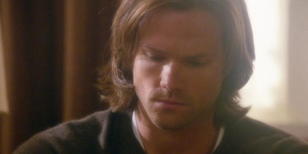 Sam looking down sadly in Supernatural