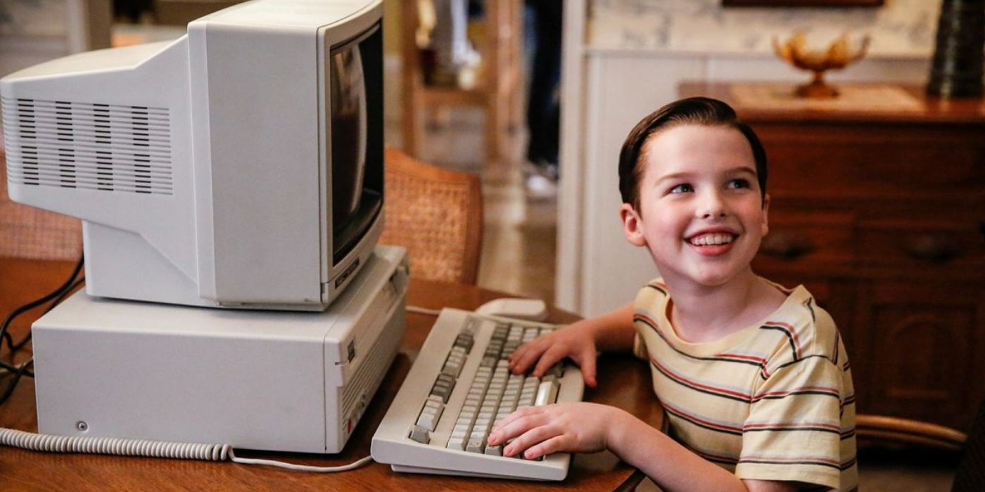 Sheldon looking happy at a computer in Young Sheldon