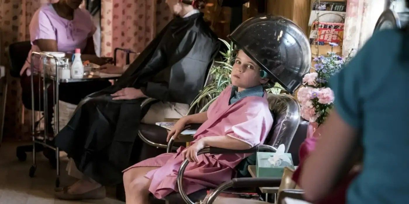 Sheldon sitting under a hair drying in a salon from Young Sheldon
