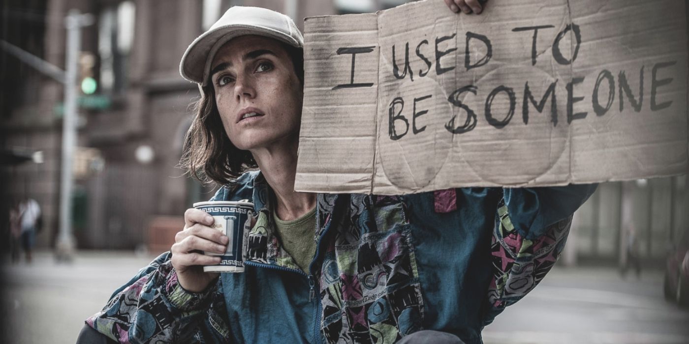 A homeless woman holding a sign in the movie Shelter.