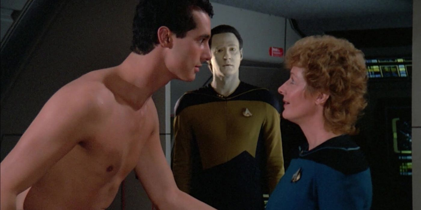 A shirtless man talks to a woman in Star Trek TNG.