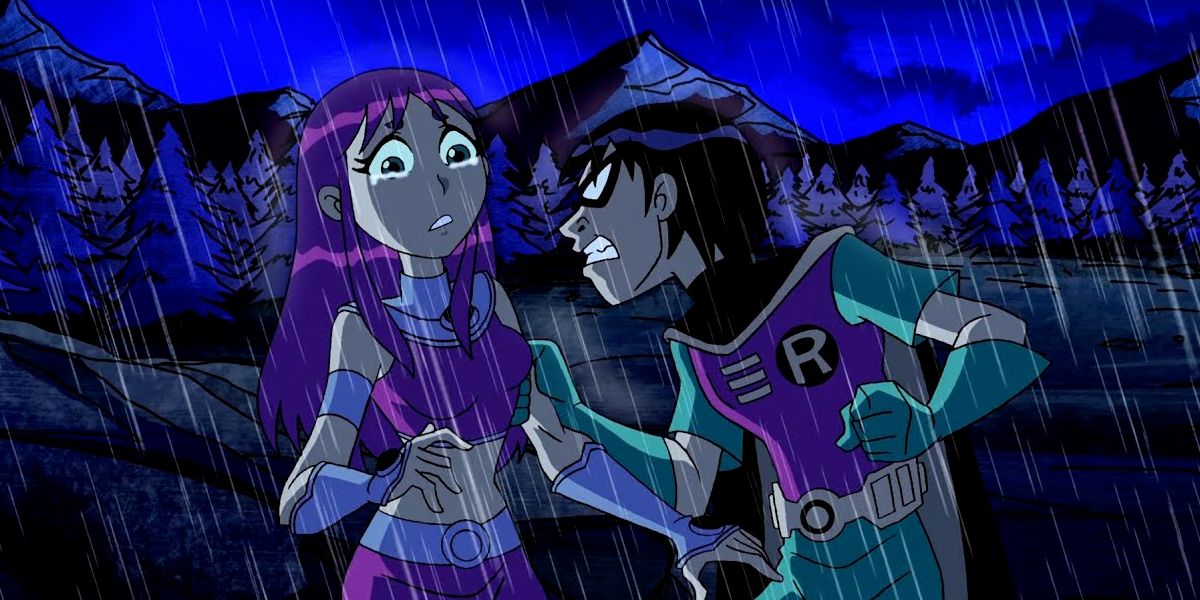 Starfire cries as Robin angrily grabs her arm in Teen Titans