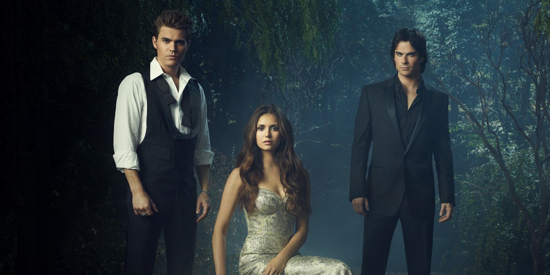 Stefan, Elena and Damon standing in a forest looking pensive