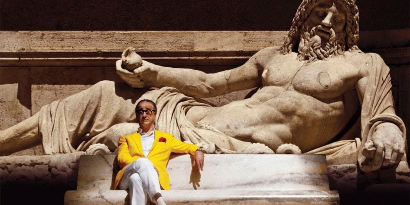 A character sitting in front of a large statue in 2013's The Great Beauty.