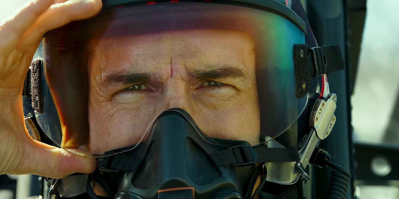Close up of Tom Cruise in character as Maverick in Top Gun 2 wearing a pilot's helmet with face shield down and oxygen mask