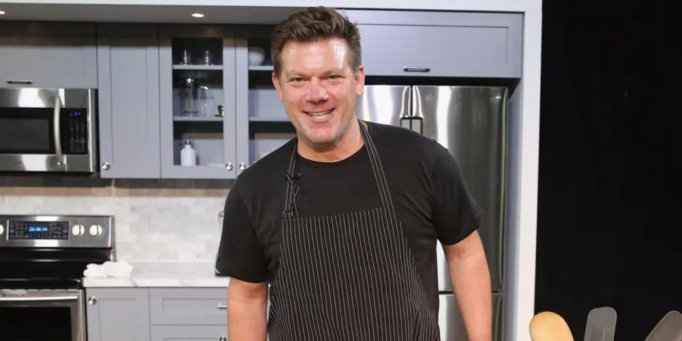 Tyler Florence wearing black t shirt and apron in kitchen