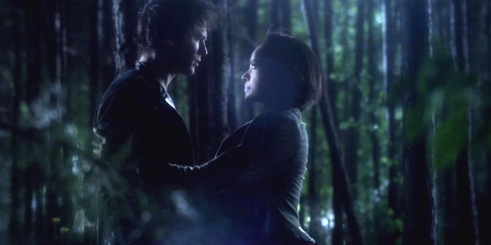 Damon and Bonnie hold on to each other in the woods