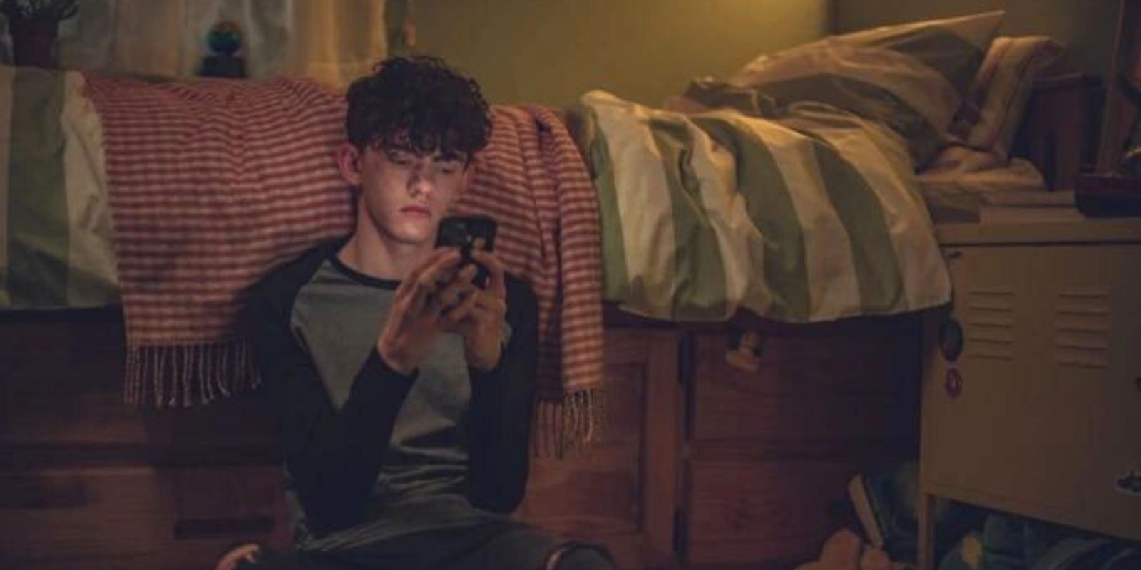 Charlie in his bedroom on his phone