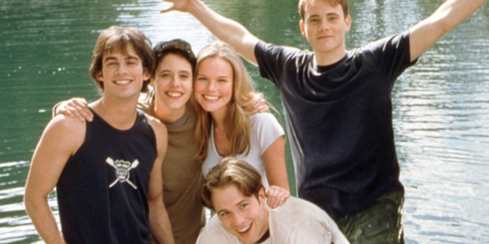 Young Americans cast posing near lake