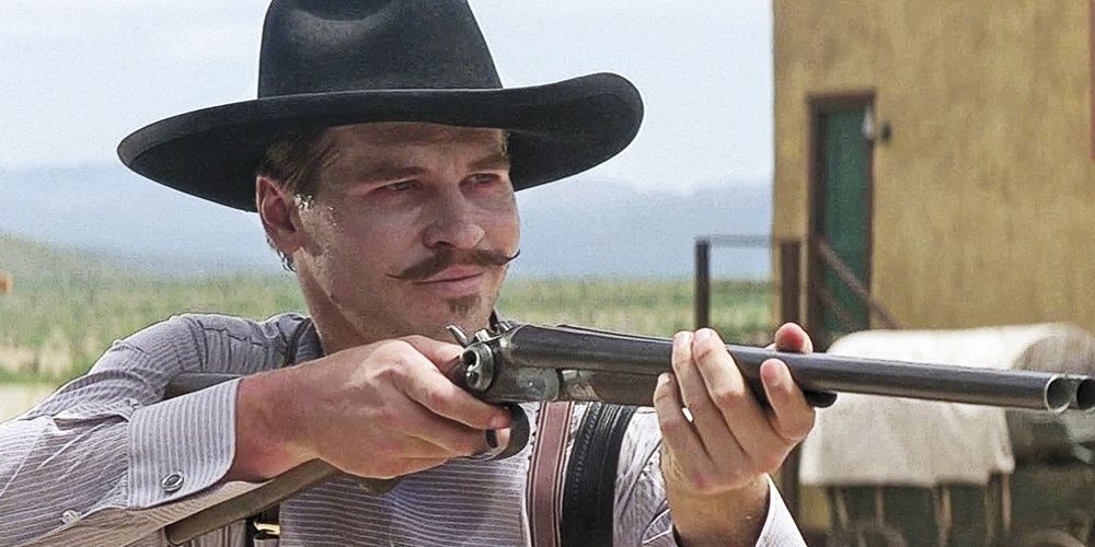 Val Kilmer as Doc Holliday with rifle scaled
