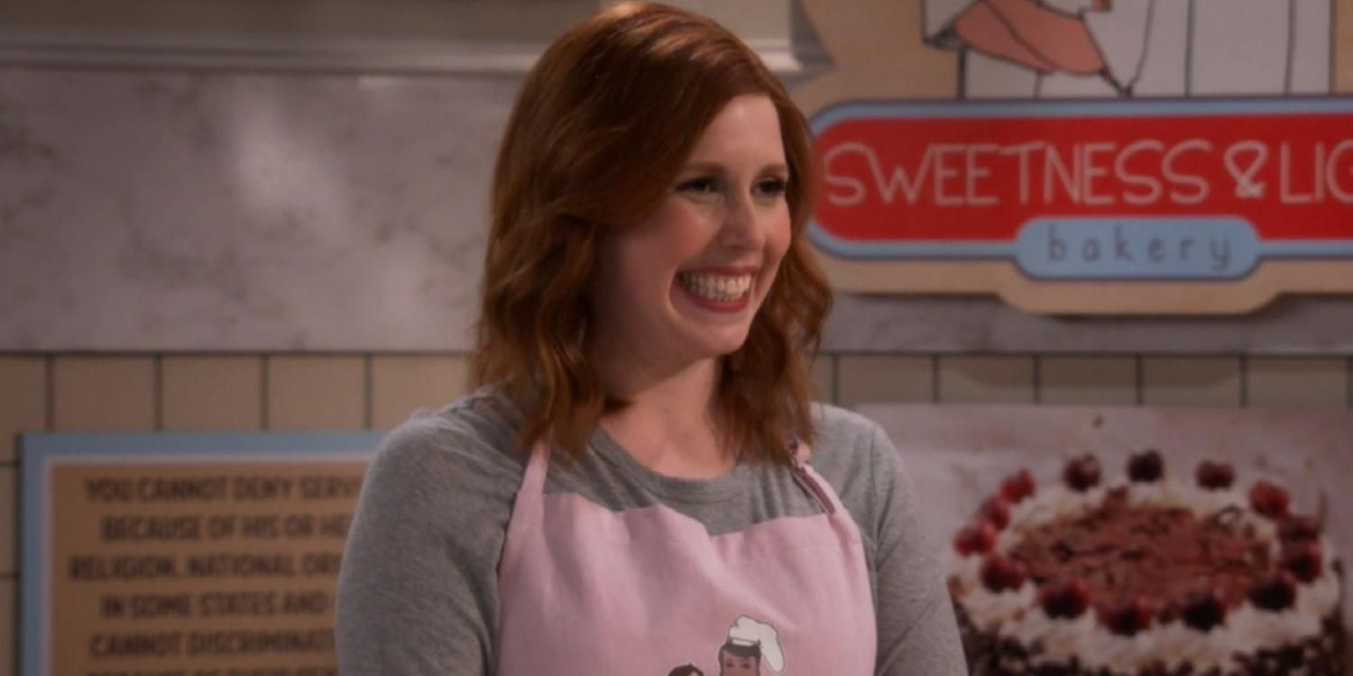 Vanessa Bayer smiling as the owner of a cake shop on Will & Grace