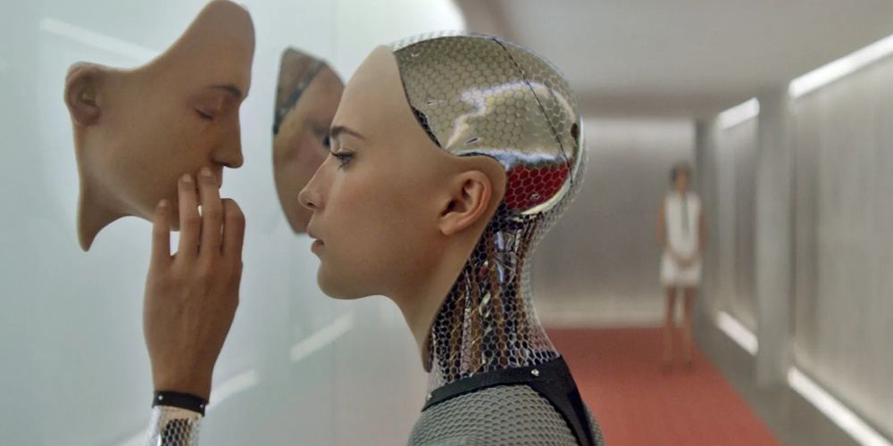 Ava touches a face mounted to a wall in Ex Machina